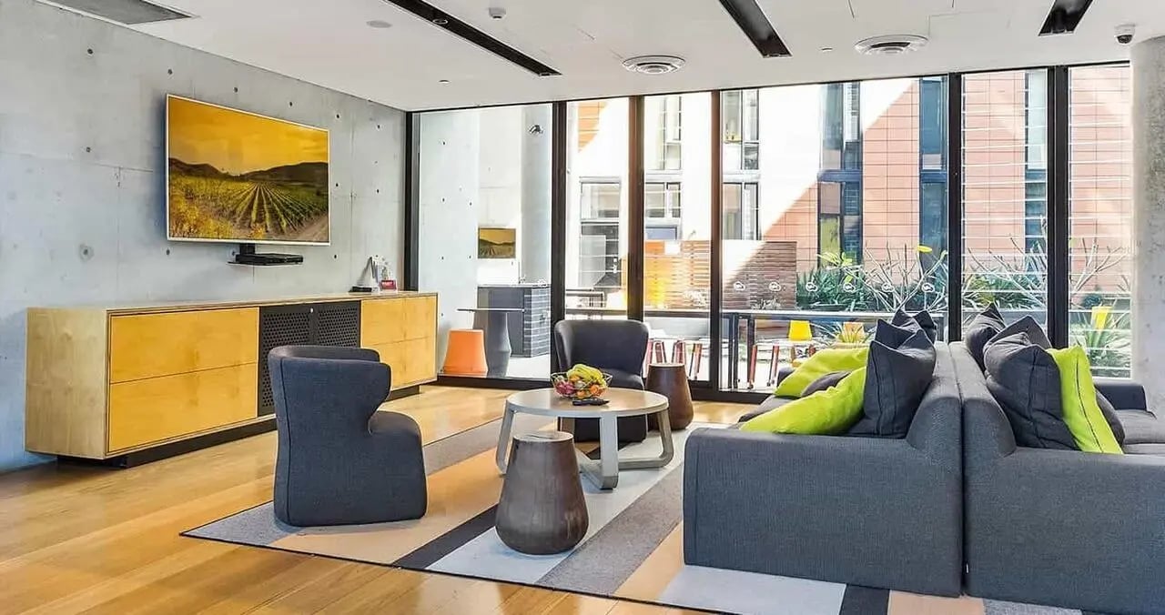 Modern lounge with gray sofas and artwork living room at Iglu Chatswood in Sydney Student Accommodation