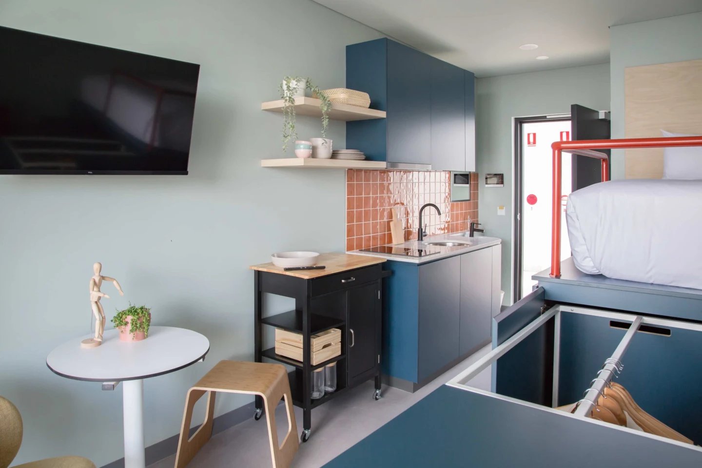 Bed kitchen table TV and stools studio apartment at UKO Marrickville Village in Sydney Student Accommodation