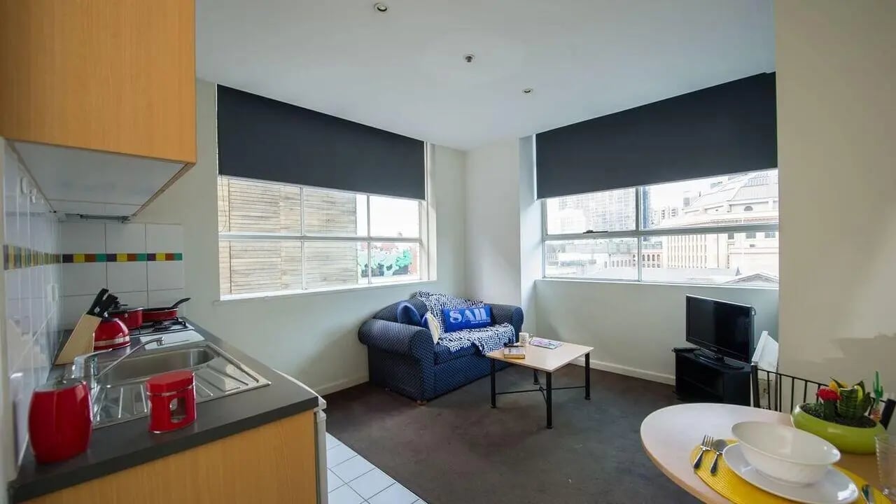 Kitchen living area with couch and table at Student Living-339 Swanston in Melbourne Student Accommodation