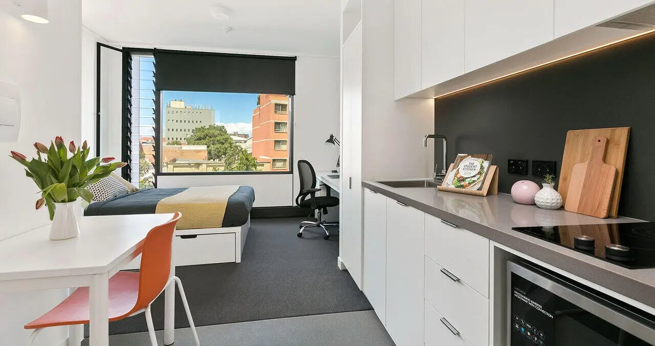 Bed desk kitchen area study bedroom at Iglu Redfern in Sydney Student Accommodation