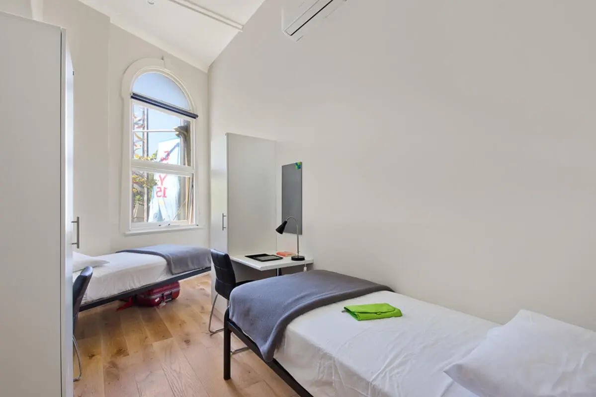 Two beds desk and wardrobe bedroom at Link2 Central in Sydney Student Accommodation