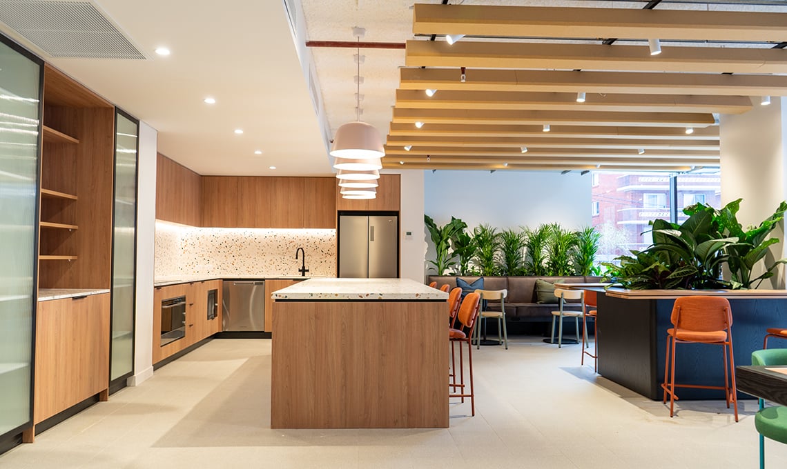 Modern communal kitchen with island and seating area at The Switch Kensington in Sydney Student Accommodation