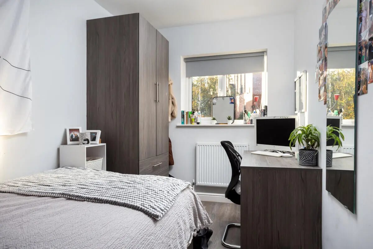 Bed desk wardrobe and mirror bedroom at Thornville Court Leeds in Leeds Student Accommodation