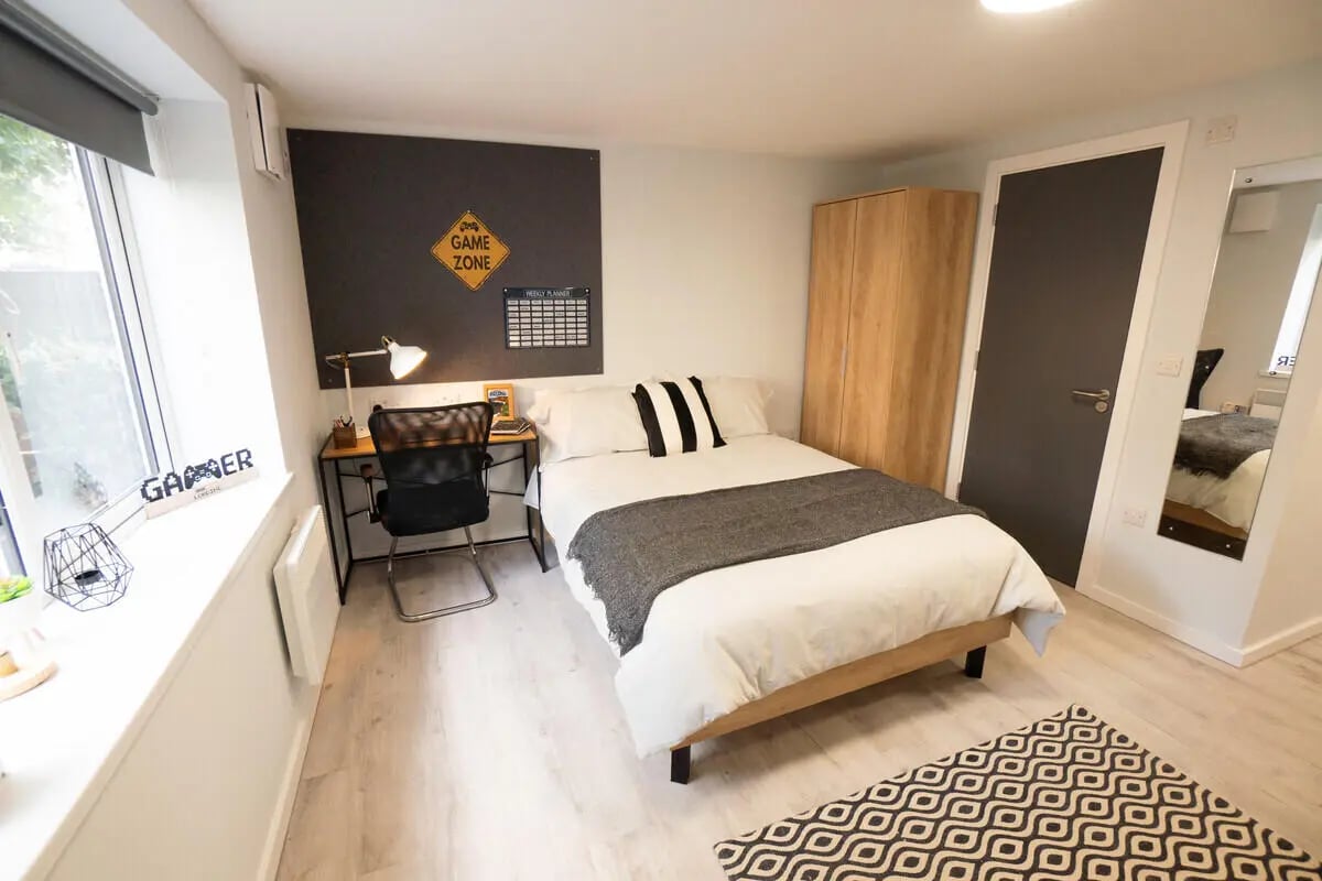 Bed desk wardrobe and rug Bedroom at Madison Gardens in Nottingham Student Accommodation