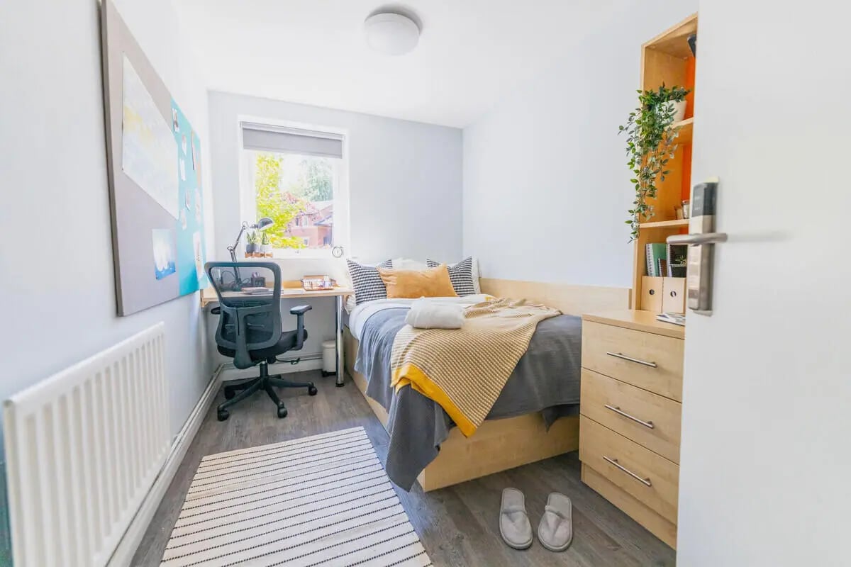 Bed desk chair rug and radiator Bedroom at Beech Gardens in Birmingham Student Accommodation