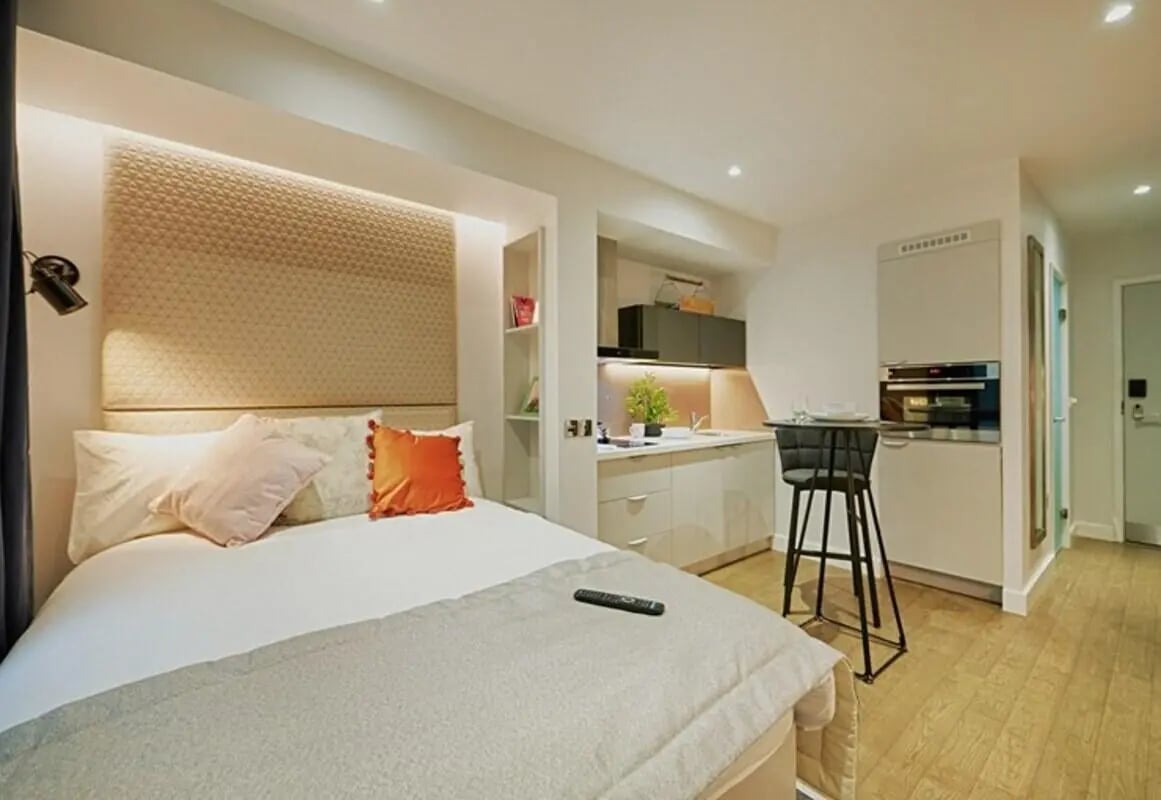 Bed kitchen area with bar stool Bedroom studio at aparto Glasgow West End in Glasgow Student Accommodation