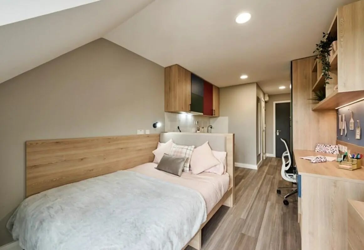 Bed desk and kitchenette modern student room at The Spireworks in Oxford Student Accommodation