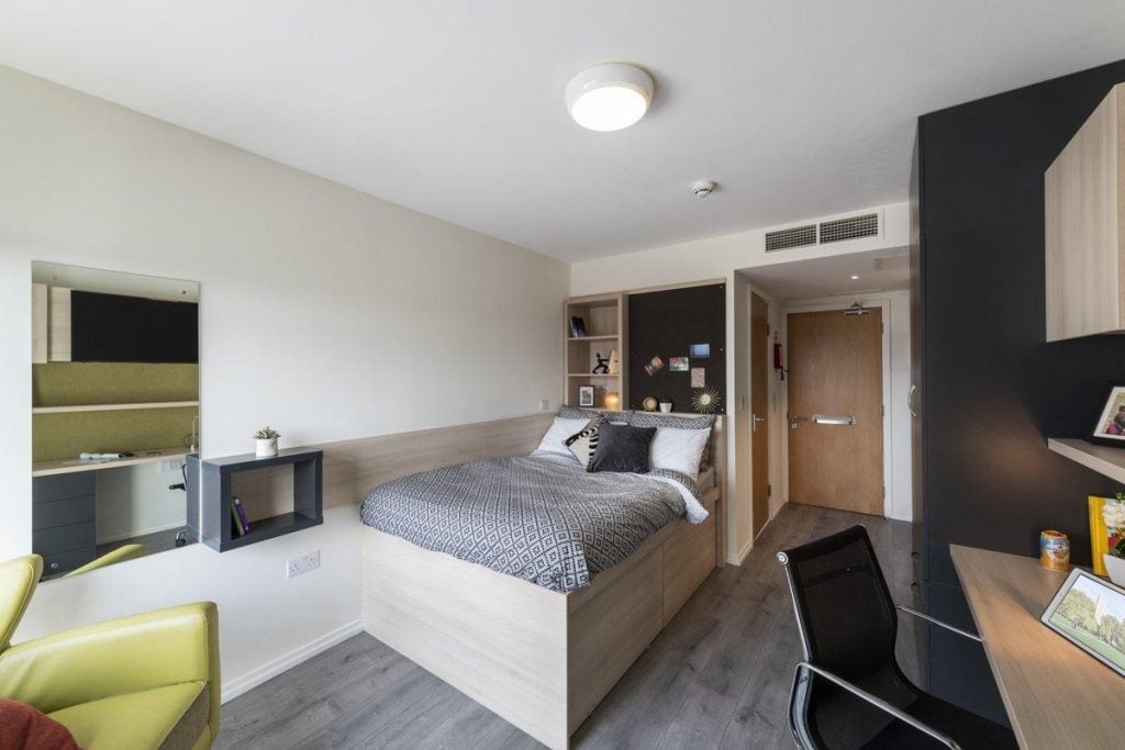 Bed desk chair and mirror bedroom at The Lyra in London Student Accommodation