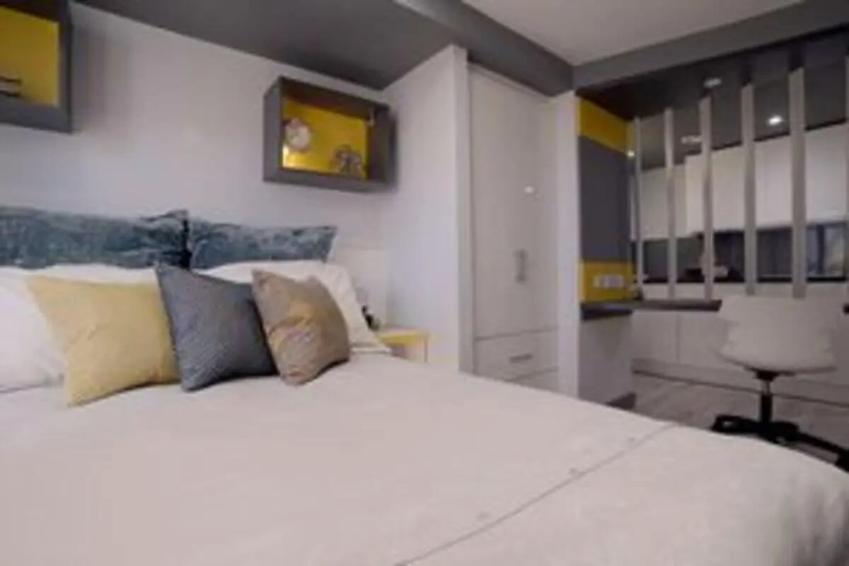 Bed with pillows wardrobe desk and chair bedroom at The Bank Leicester in Leicester Student Accommodation