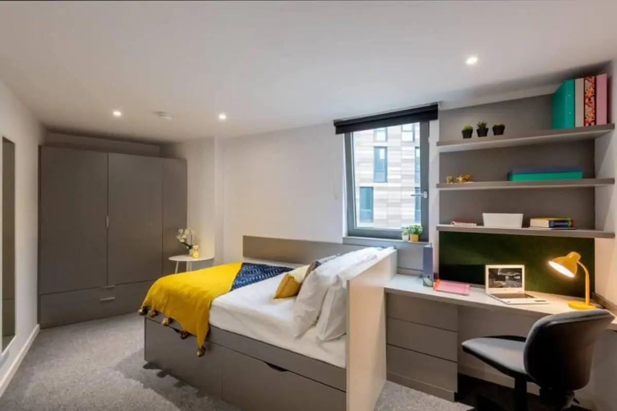 Bed desk wardrobe shelves and laptop bedroom at Verde in Newcastle Upon Tyne Student Accommodation