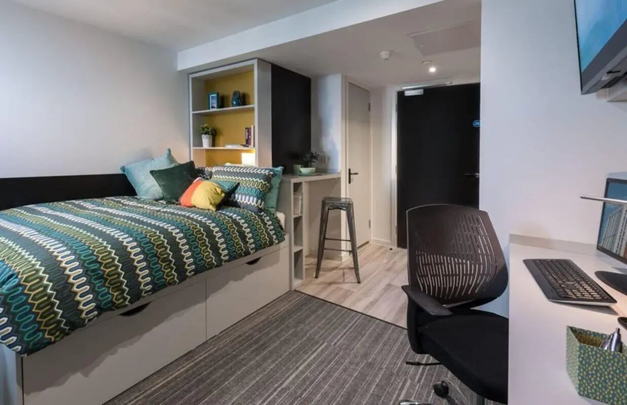 Bed study desk and chair student room at City Village in Coventry Student Accommodation