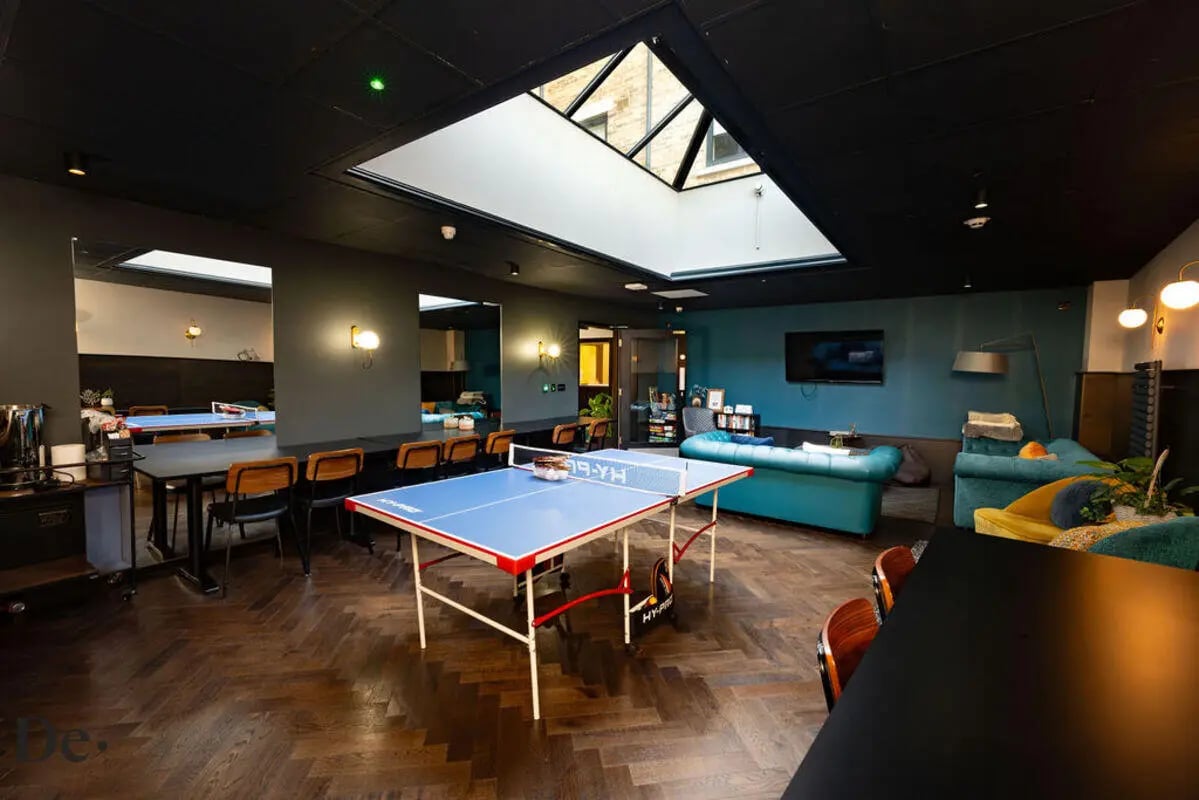 Ping pong table sofas television common area at Castle Hill in Cambridge Student Accommodation