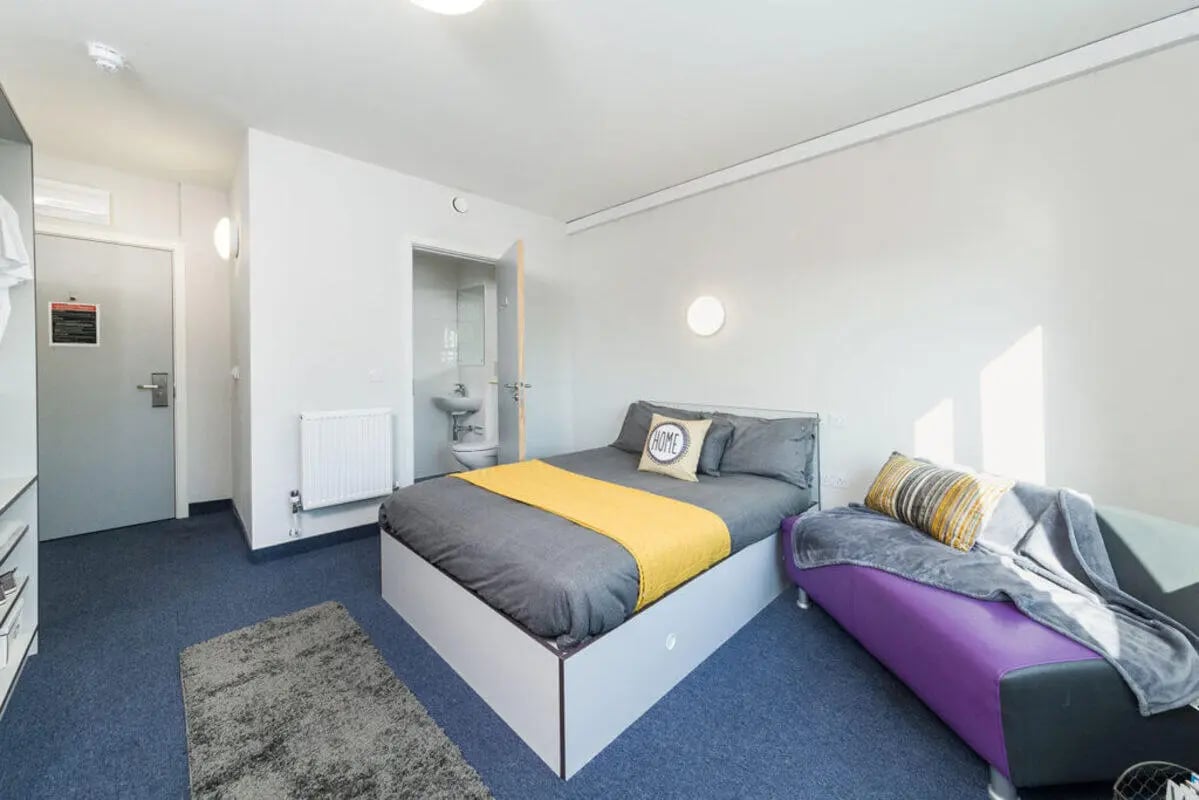 Bed couch toilet sink radiator bedroom living room at Quayside Court in Newcastle Upon Tyne Student Accommodation