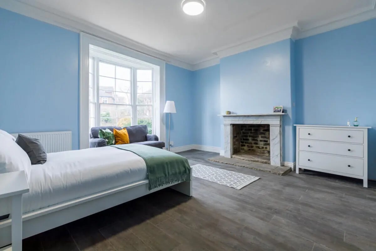Bed sofa fireplace dresser bedroom at Holgate Road in York Student Accommodation