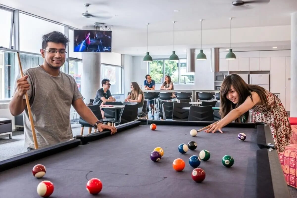 Students playing pool with colorful balls lounge area at Student Village - University of Melbourne Campus in Melbourne Student Accommodation