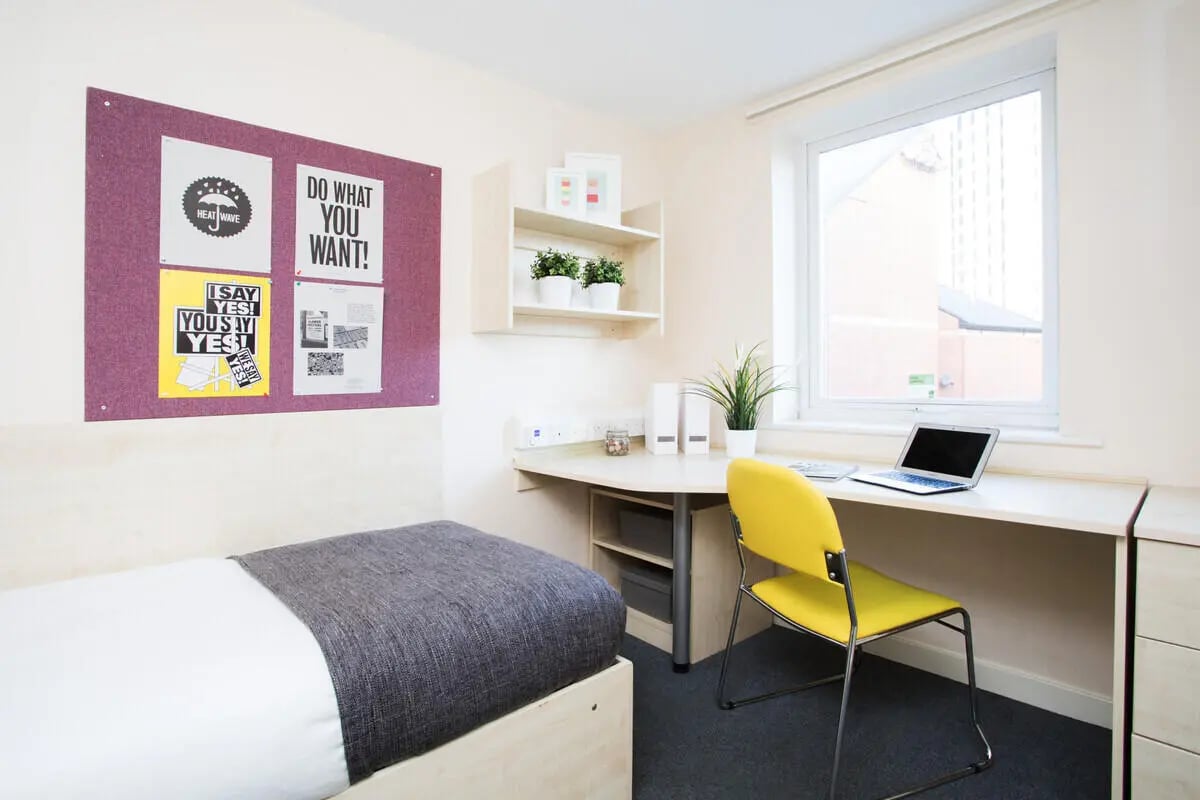 Bed desk chair laptop bulletin board study area at The Grange Leicester in Leicester Student Accommodation