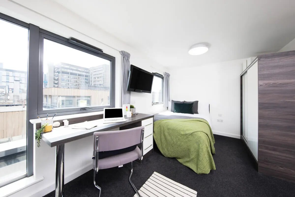 Desk chair laptop bed and television bedroom at Prospect Point in Liverpool Student Accommodation
