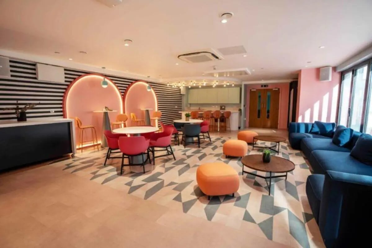 Modern common area with seating and kitchen. at Oxford Point in Bournemouth Student Accommodation