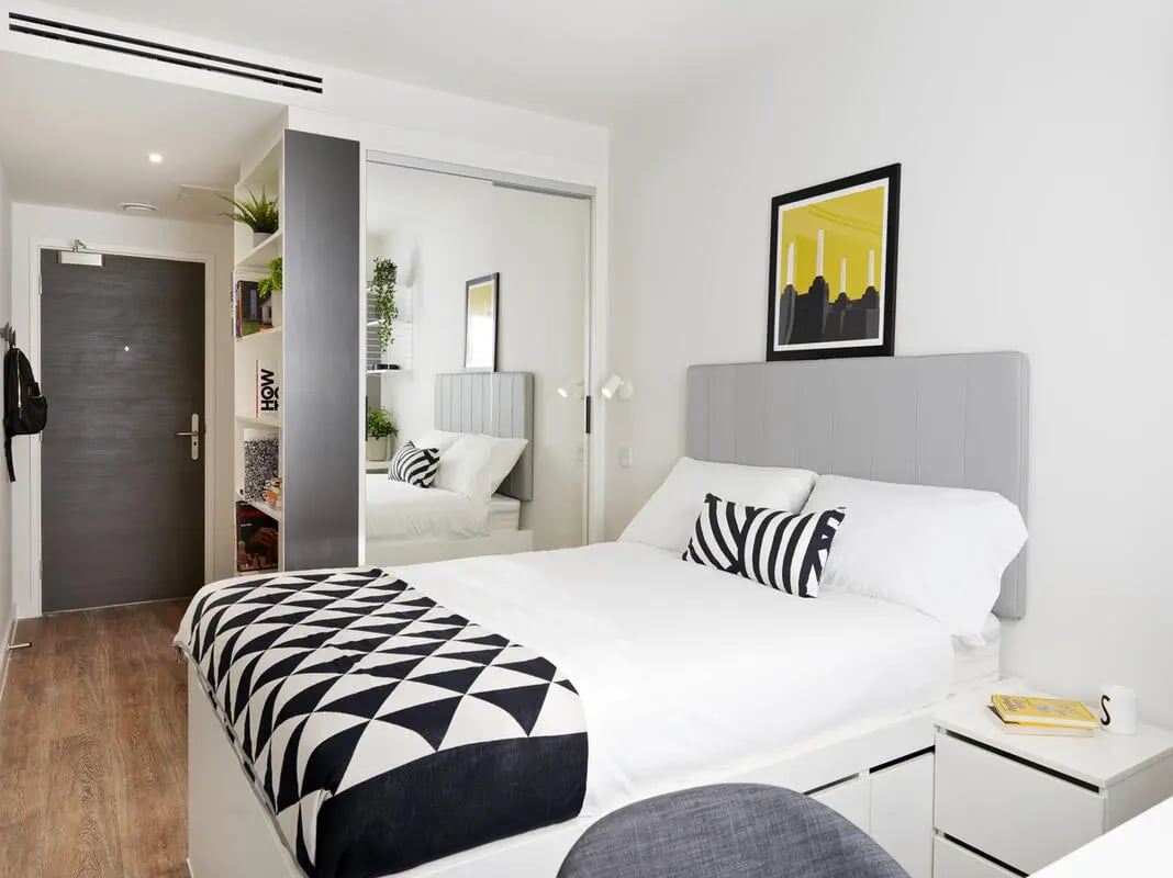 Bed with patterned throw grey headboard bedside table bedroom at Student Castle Oxford in Oxford Student Accommodation