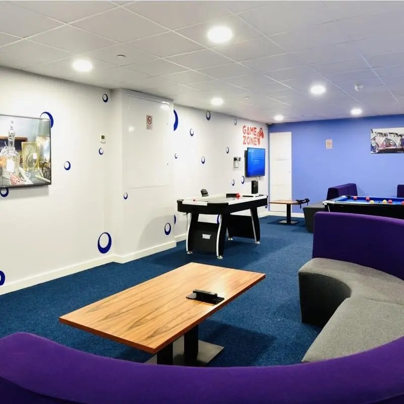 Air hockey table pool table lounge seating communal area at The Courtyard Block C in Huddersfield Student Accommodation