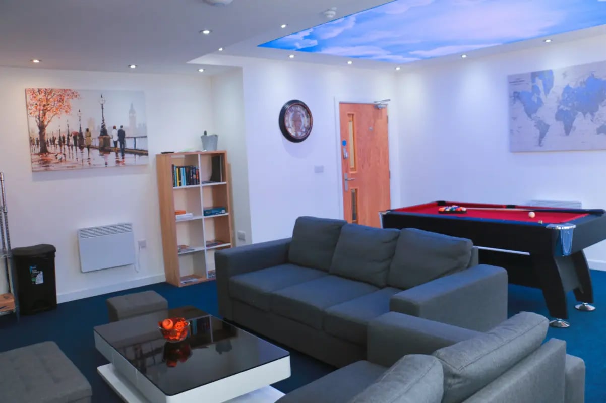 Sofas pool table and art in living room at Renaissance House in Leicester Student Accommodation