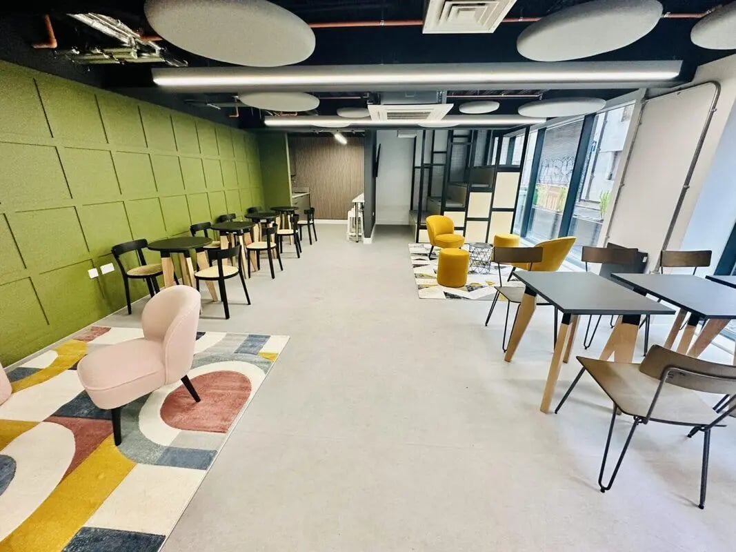 Tables chairs and lounge seating communal area at The Nest Leicester in Leicester Student Accommodation
