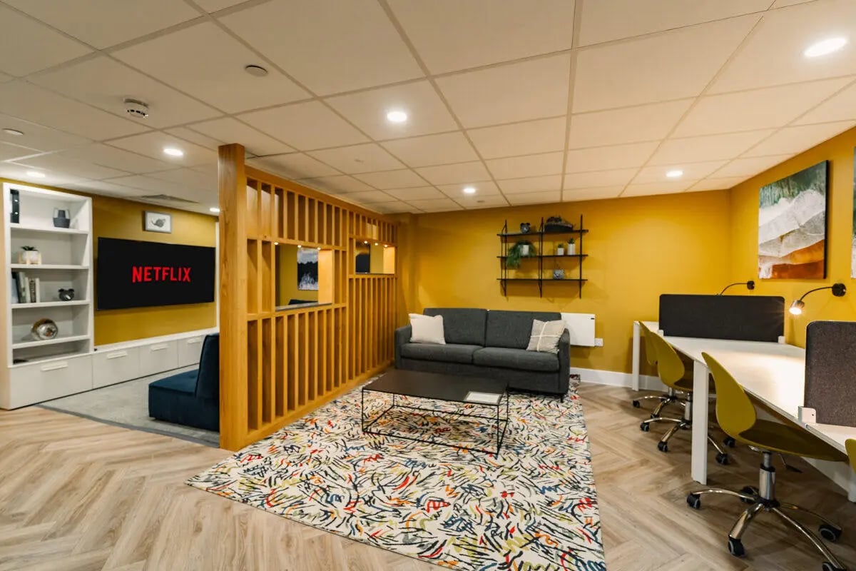 Study area with desks sofas and television lounge at Hydrogen Falmouth in Falmouth Student Accommodation