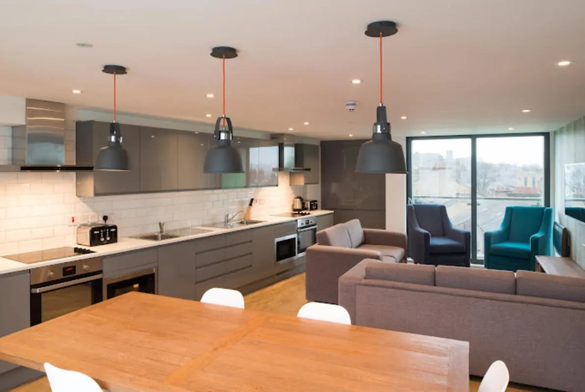 Modern kitchen with sofas and chairs living area at CityBlock Marton Street in Lancaster Student Accommodation