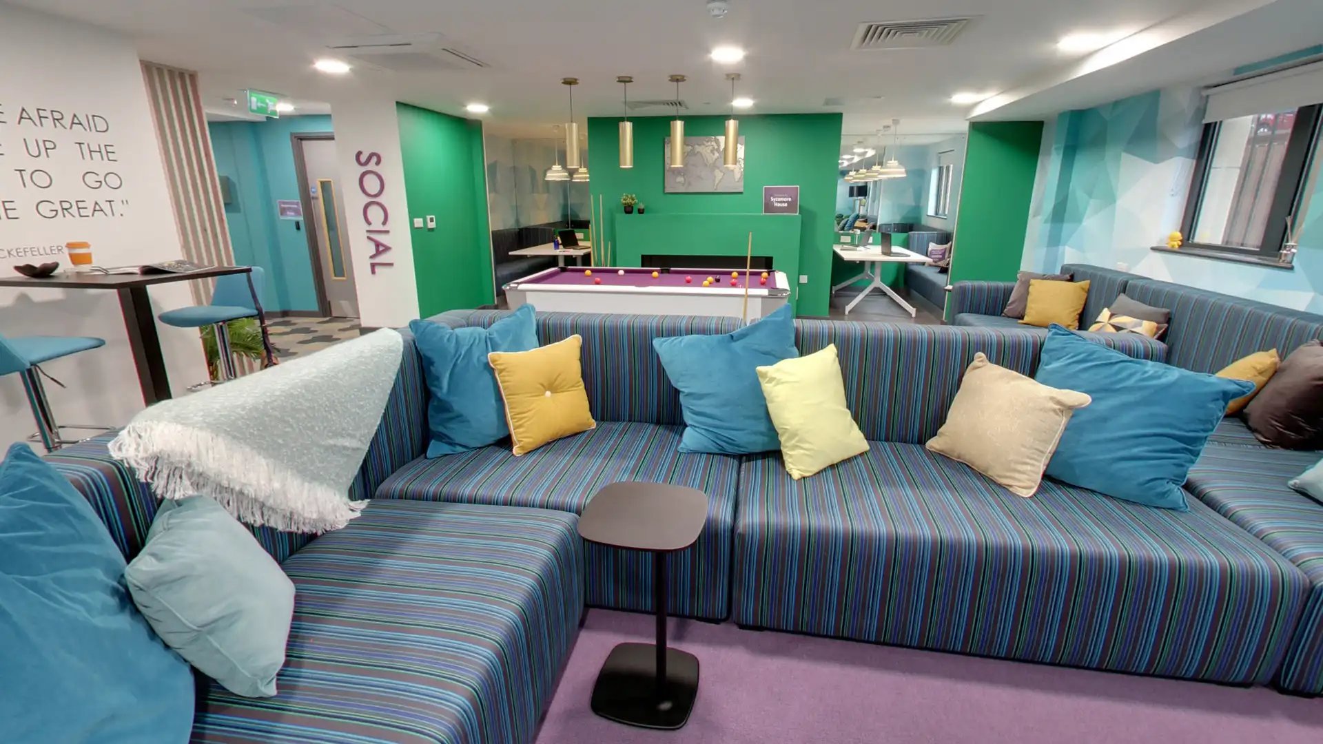Striped sectional sofas pool table and social area lounge at Sycamore House in Leeds Student Accommodation