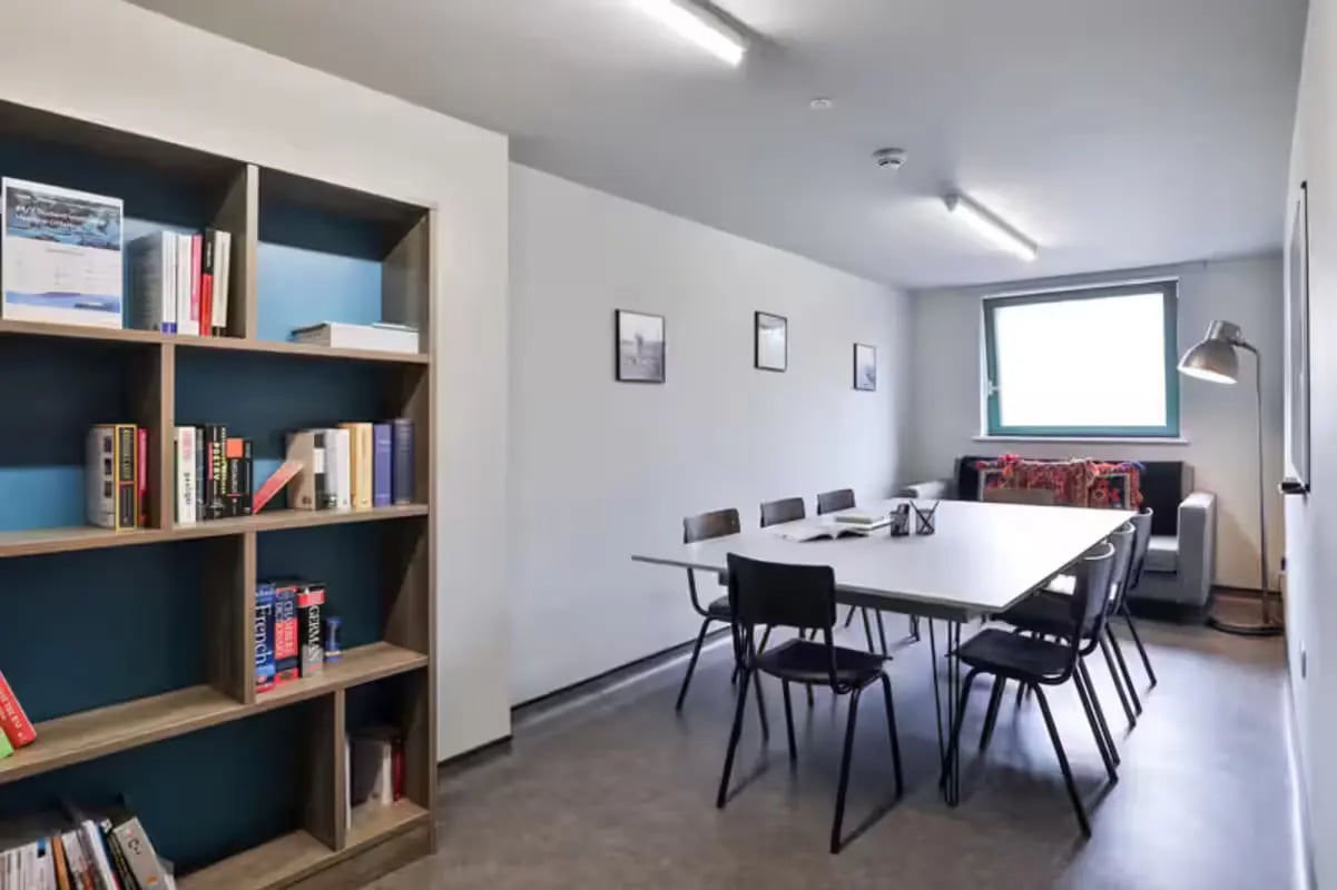 Bookshelf dining table chairs window lounge living room at Ayton House in St Andrews Student Accommodation