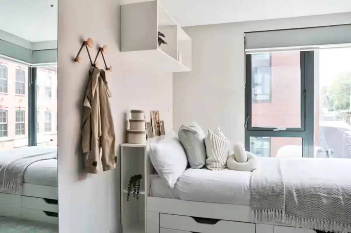 White bed with pillows and coat rack bedroom at Portobello House in Sheffield Student Accommodation