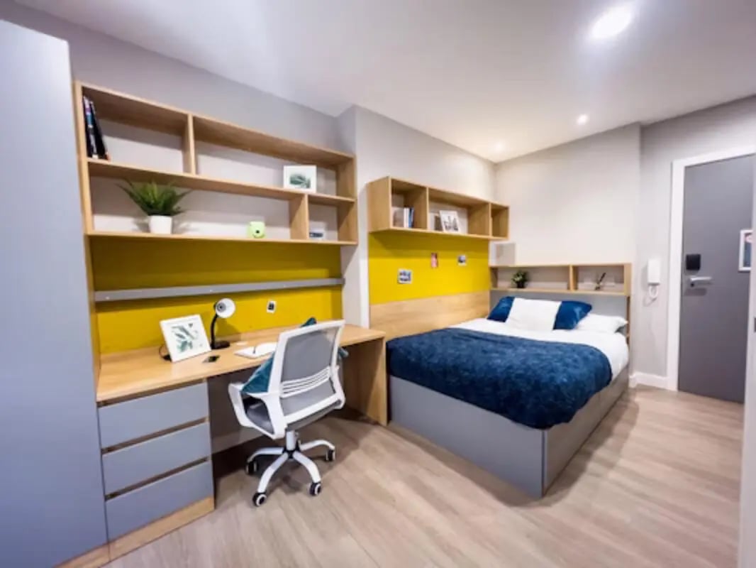 Bed desk chair shelves in a student bedroom at Panmure Court in Edinburgh Student Accommodation
