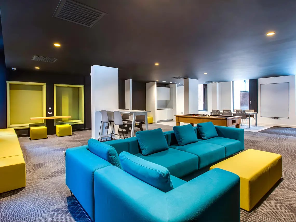 Blue sectional sofa pool table study booths living room at Lee Point in Cork Student Accommodation