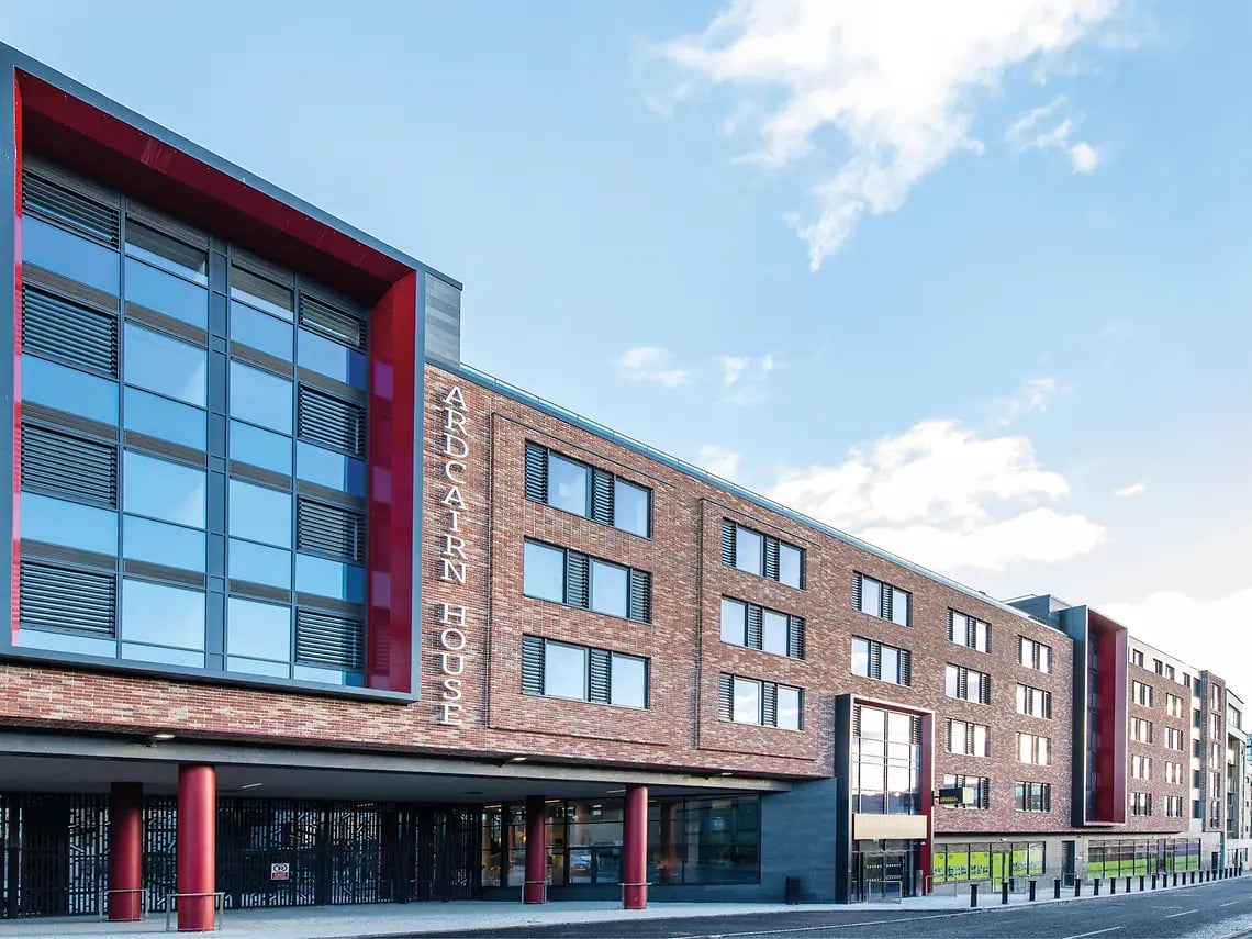 Modern brick student accommodation with red accents exterior at Ardcairn House in Dublin Student Accommodation
