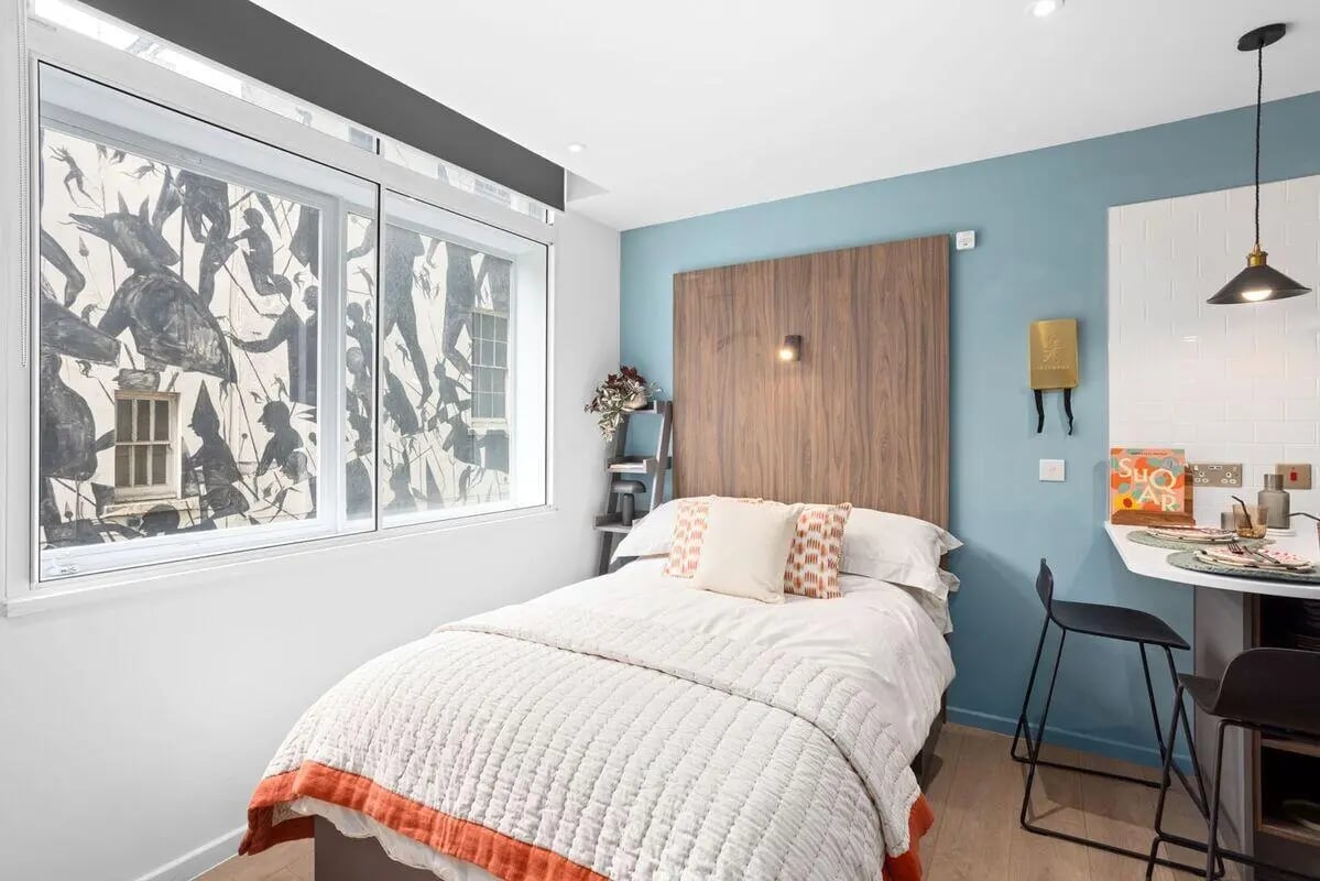 Bed with pillows and artwork window bedroom at Summit House in Cardiff Student Accommodation