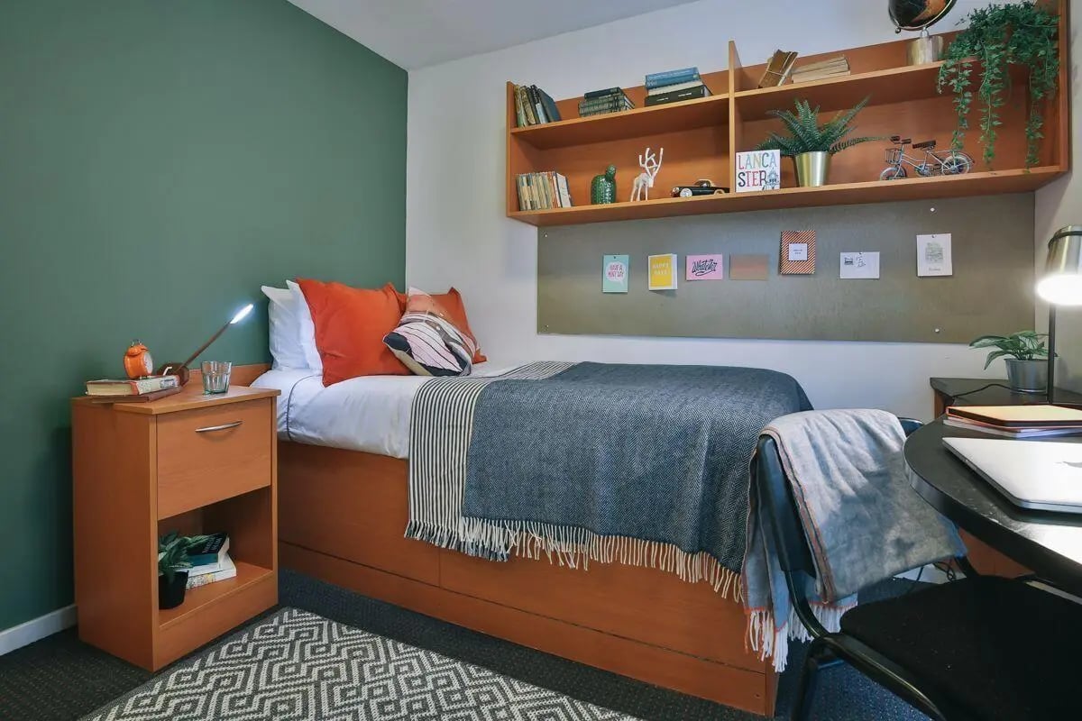 Bed pillows blanket bedside table desk lamp bedroom at 77 Penny Street in Lancaster Student Accommodation