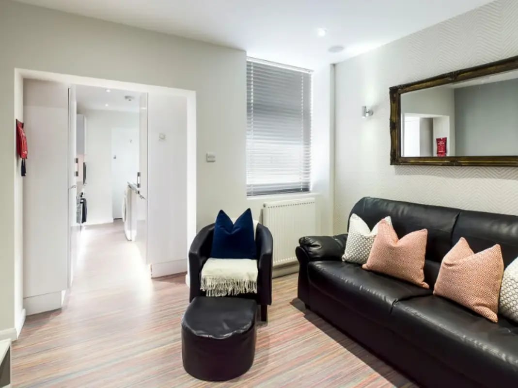 Black leather sofa and chair living room at 29 Guildford Street in Stoke-On-Trent Student Accommodation
