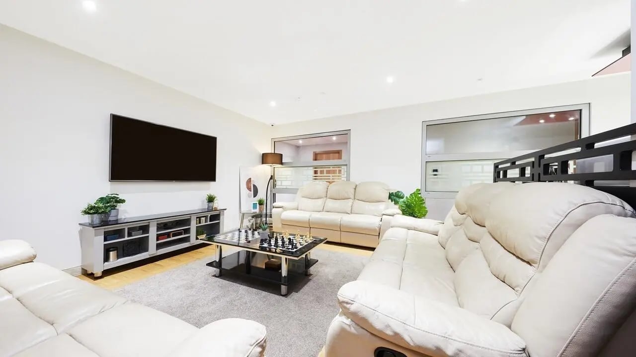 Cream leather sofas coffee table TV living room at Corporation Village in Coventry Student Accommodation