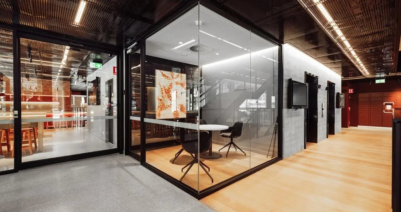 Glass room with table chairs and art study area at Iglu Flagstaff Gardens in Melbourne Student Accommodation