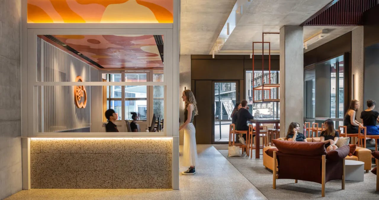 People in lounge area and reception area living room at Iglu Melbourne Central in Melbourne Student Accommodation