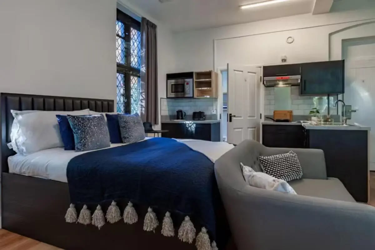 Bed kitchen area and sofa living room at The Priory in Leeds Student Accommodation