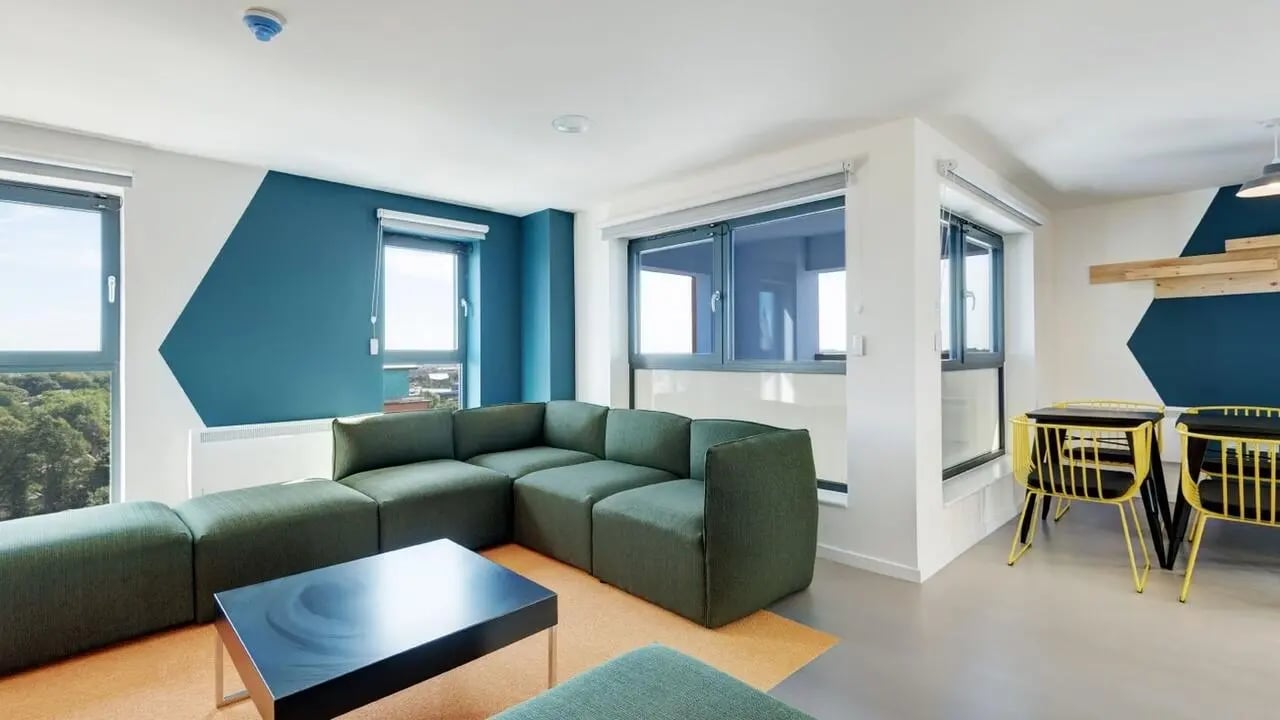 Green sectional couch black coffee table living room at Collegiate Merlin Heights in Leicester Student Accommodation