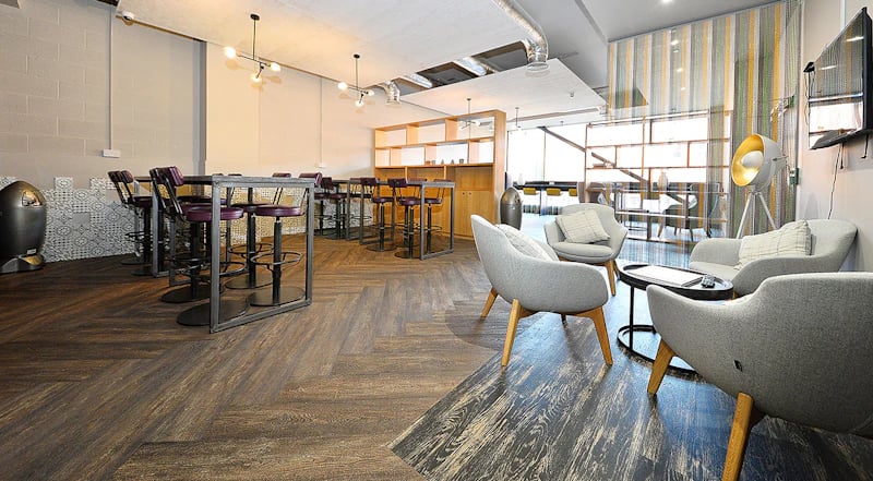 High top tables and bar stools lounge seating with coffee table common area at 800 Bristol Road in Birmingham Student Accommodation