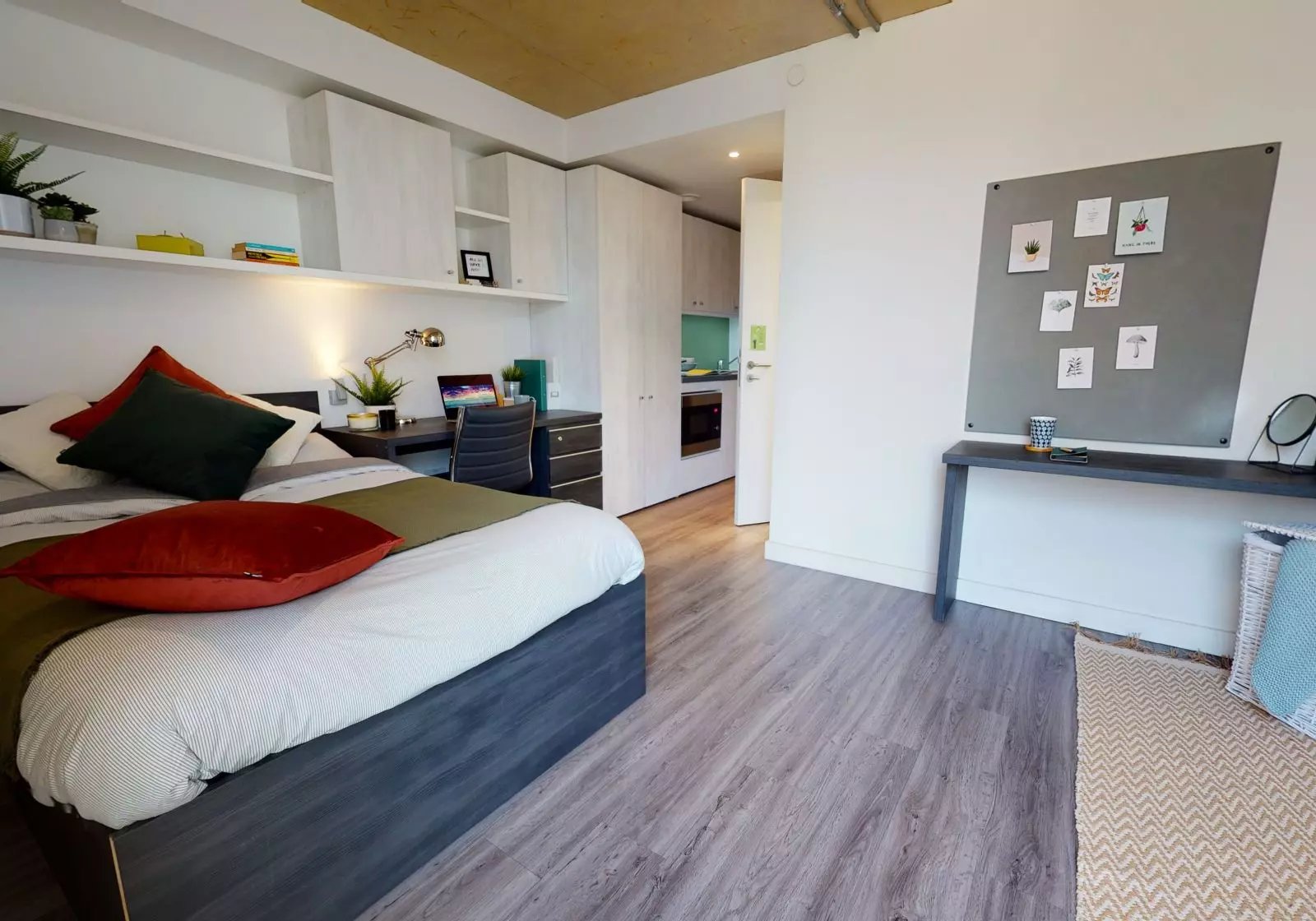 Bed desk and kitchen area view interior at iQ Aldgate in London Student Accommodation