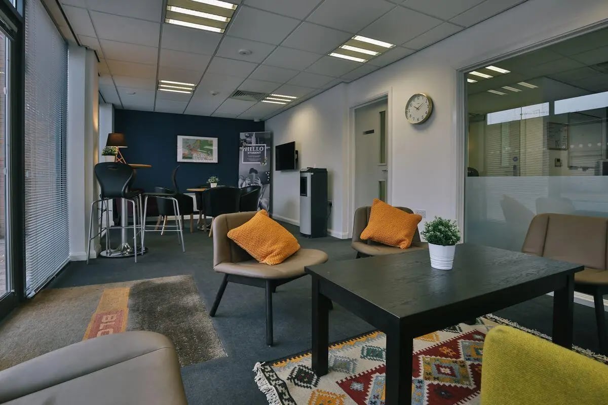 Chairs table rug and pillows communal area at Applegate Place in Leicester Student Accommodation