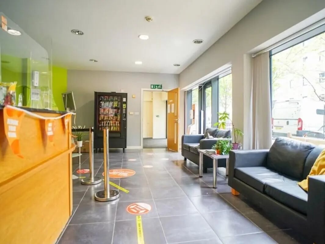 Lounge with sofas vending machine and reception area living room at Beaverbank Place in Edinburgh Student Accommodation