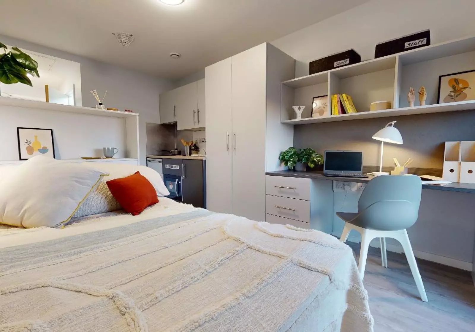 Bed desk and kitchen area studio at iQ City in London Student Accommodation
