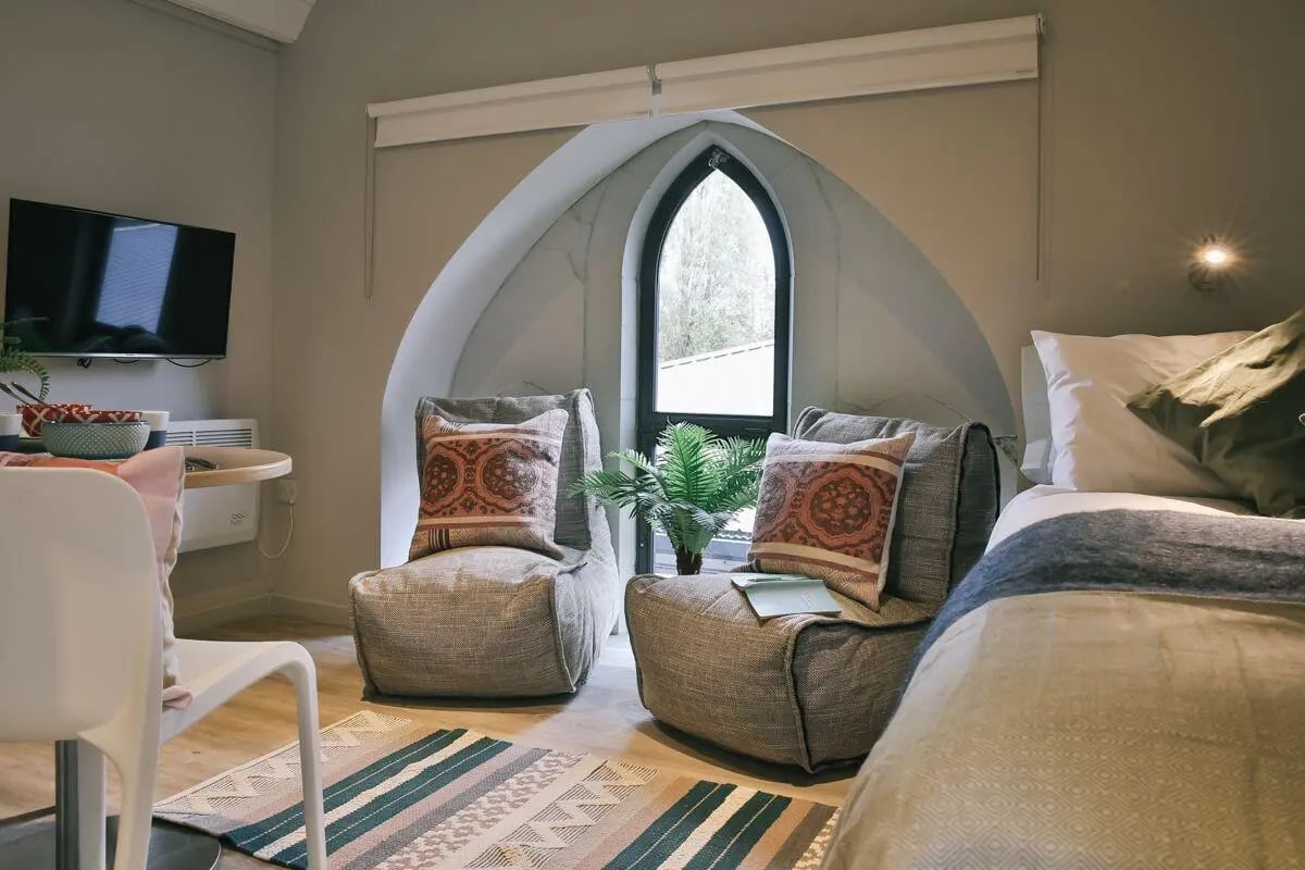 Two beanbag chairs bed and tv study area at The Chapel in Manchester Student Accommodation
