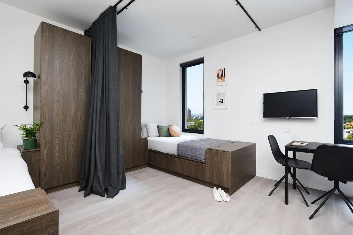 Bed wardrobe desk and TV bedroom at Scape Cornell Place in Melbourne Student Accommodation
