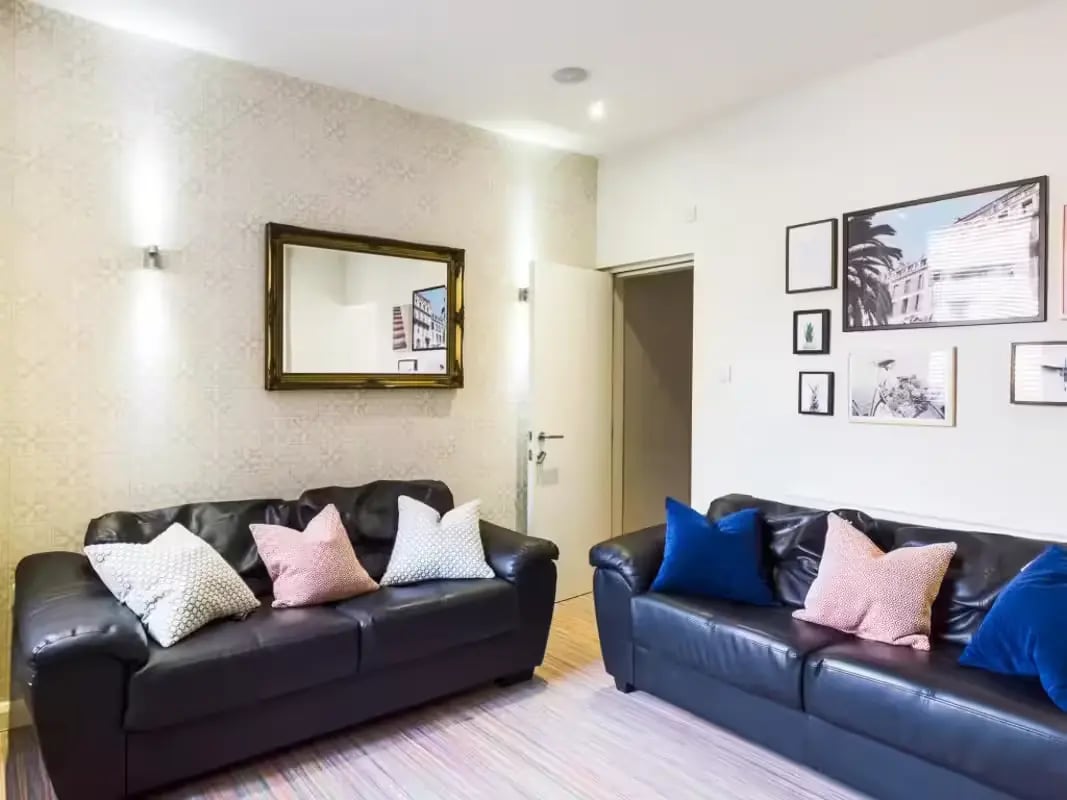 Two black sofas with decorative pillows living room at 86 Beresford Street in Stoke-On-Trent Student Accommodation